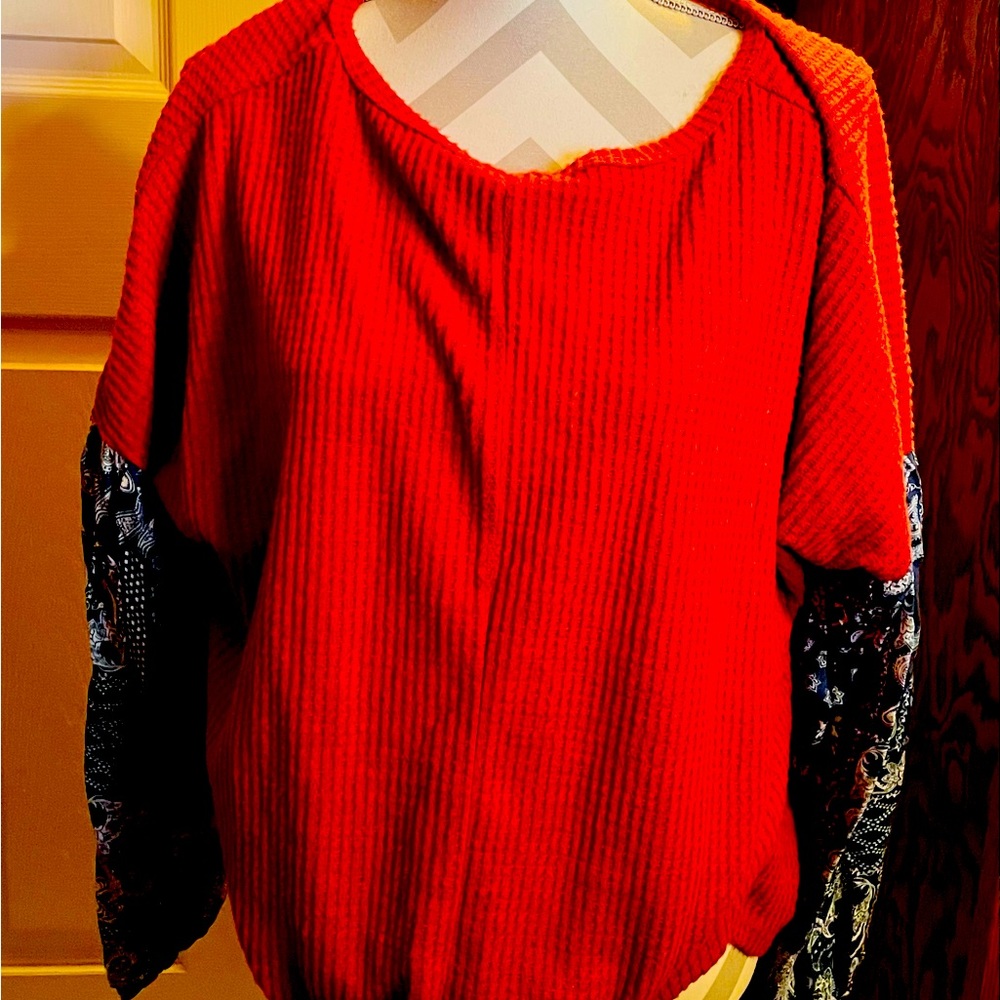 Red top with navy paisley print sleeves